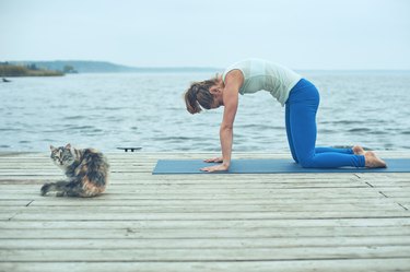 Beautiful young woman practices yoga poses for dextroscoliosis