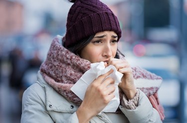 Woman dressed for winter and sick with the flu