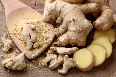Ginger root and ginger powder on a table as a spice for weight loss