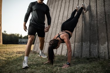 Two friends exercising together in park