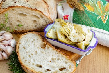 Homemade fresh italian bread and artichokes in brine with spices