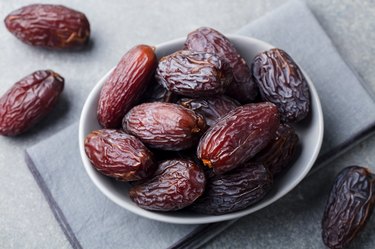 Dried Medjool dates in bowl.