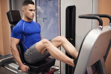 Man exercising on leg press machine