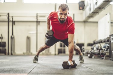 Man doing a renegade row with dumbbells