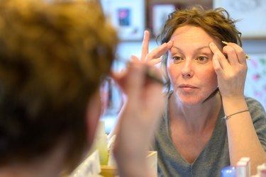 Attractive woman looking at her reflection