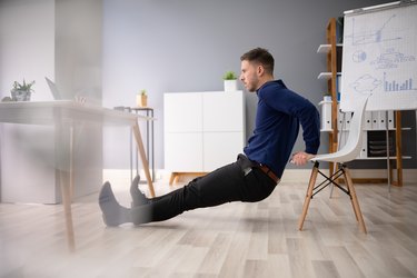 Man doing tricep dips on chair.