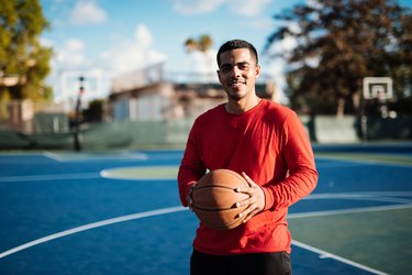 Portrait of Latino guy with basketball ball