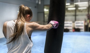 Young woman boxing in gym