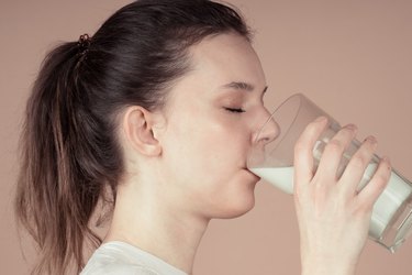 young woman drinking glass of milk
