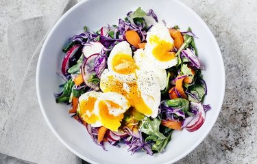 Fresh salad with soft-boiled eggs