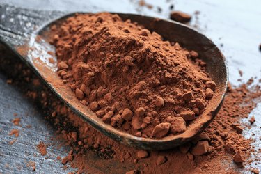 Close-Up Of Spoon With Cocoa Powder On Table