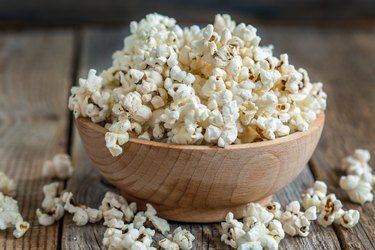 Wooden bowl filled with air-popped popcorn