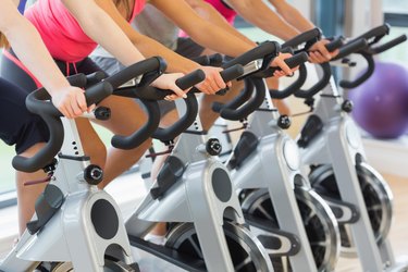 Mid section of people working out at exercising class