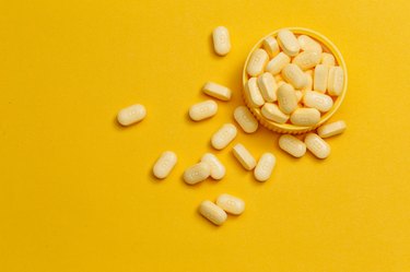 vitamin B12 tablets on yellow background
