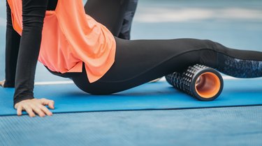 Midsection Of Woman Exercising On Mat