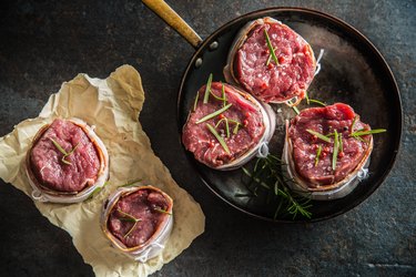 Top of view beef tenderloin steak wrapped in bacon stored into the pan.