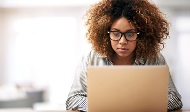 A woman searching for diet advice online using her laptop