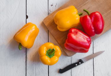 Fresh bell peppers on cutting board