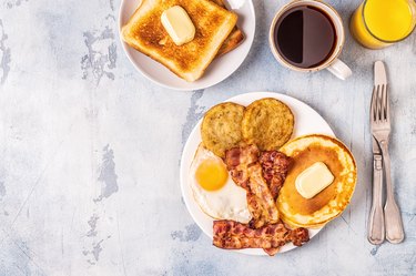 Healthy Full American Breakfast with Eggs Bacon Pancakes and Latkes