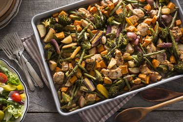 Top view of a sheet pan with slow-carb foods including chicken and vegetables