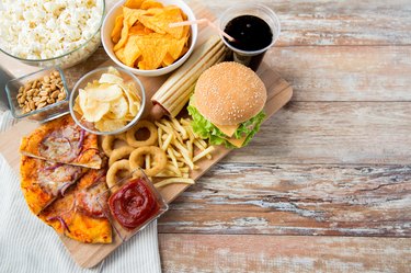 close up of fast food snacks and drink on table