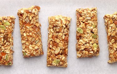 Homemade granola bars on white baking paper.