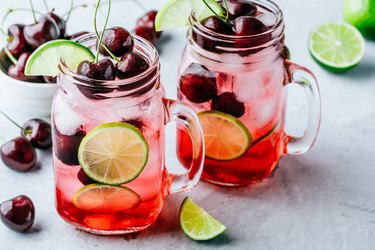 Cherry Limeade or Lemonade in glass mason jar. Ice cold summer drink.