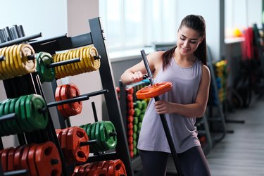 Beautiful sporty young brunette woman in sportswear in the gym.