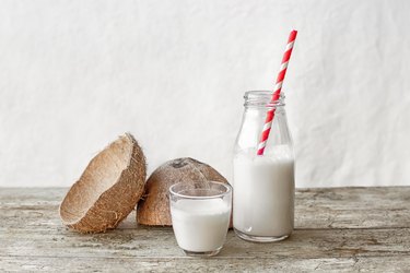 Coconut milk and coconut fruit cut in half