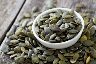 pumpkin seed kernels on wooden surface