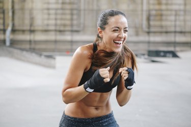 Young woman boxing in urban setting