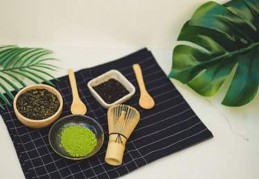 matcha green tea benefits and bamboo whisk on white background. tradition japanese tea ceremonial.