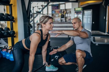 Woman practicing dead lifting