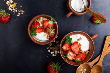 Breakfast with muesli, yogurt and fresh strawberries