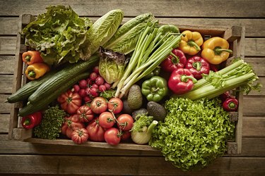 Still life fresh, organic, healthy vegetable harvest variety in wood crate