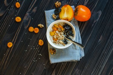 Oatmeal with Persimmon on a Black Wooden Table