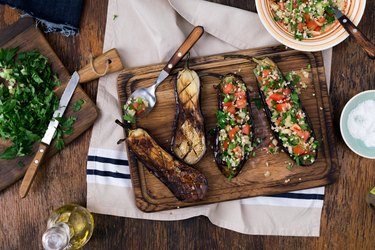 Stuffed eggplant recipes with porridge bulgur and vegetables on the cutting board. Cooking healthy food concept