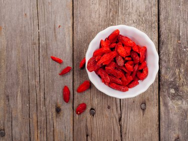 Gojiberries in a bowl on wooden background