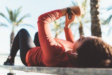 Sportswoman checking heart rate on smartwatch