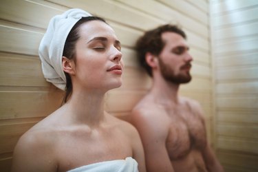 couple using a sauna for post-workout recovery