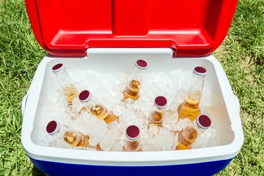 Bottles of beer in cooler box with ice
