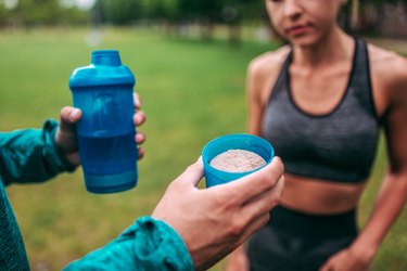 Preparing protein shake outdoors. Close-up.