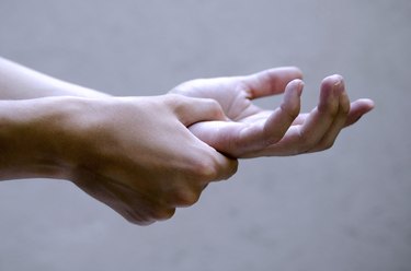 Man holding hand joint in pain. Medical health issue.Close up,isolated young man hands