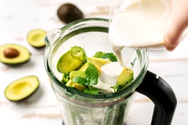 Top view of blender with avocado pieces