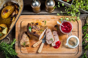 Freshly served venison with cranberries and rosemary