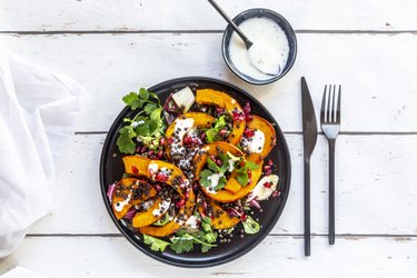 Autumnal salad with fried pumpkin, lentils, radicchio, pomegranate seeds, leaf salad and parsley with dressing