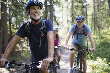 Beginner cyclists biking on a wooded trail