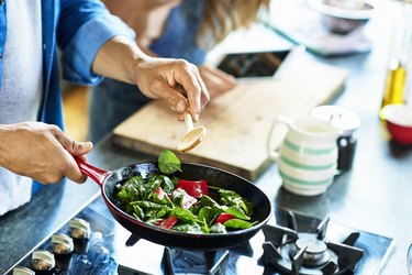 Man frying vegetables making food list for diabetes and high blood pressure