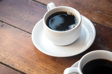 Coffee Mug on Wooden Table in the morning.