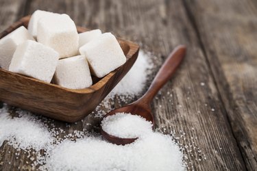 Bowl with sugar and a wooden spoon